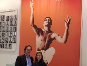 Elizabeth and David in front of giant Alvin Ailey dance poster